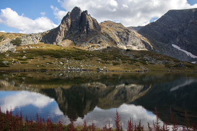 Scenic view of lake and mountains against sky