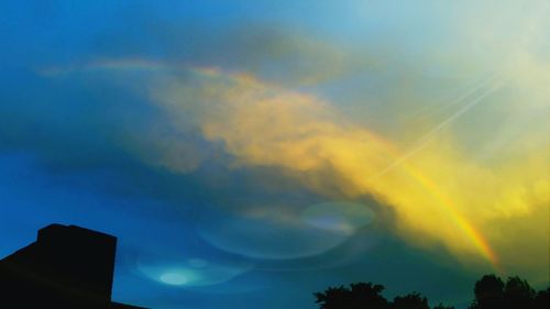 Low angle view of built structure against sky at sunset