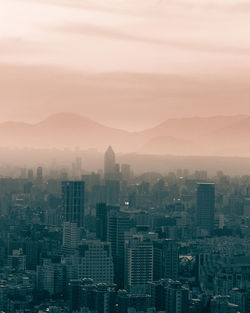 High angle view of buildings in city against sky during sunset