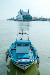 Boats moored in sea against sky