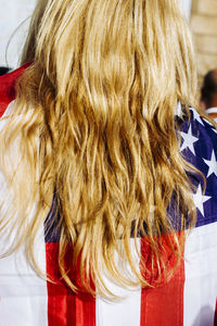 Rear view of blond woman with american flag