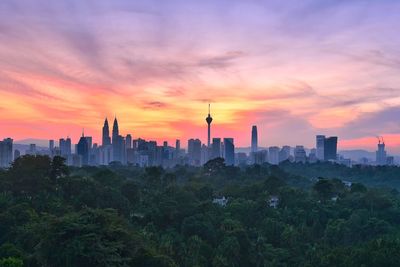 View of buildings against cloudy sky during sunset