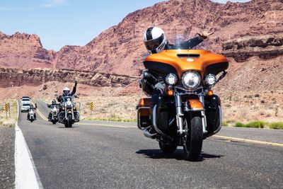 Men riding motorcycles on country road