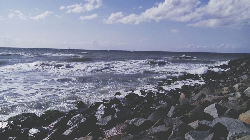 sea, water, horizon over water, wave, scenics, sky, beauty in nature, beach, surf, tranquil scene, shore, nature, tranquility, rock - object, cloud - sky, idyllic, motion, seascape, cloud, outdoors