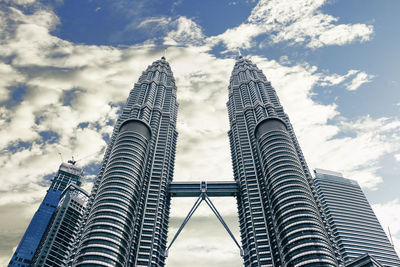 Low angle view of buildings against cloudy sky