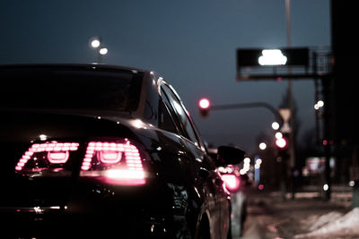 Cars in illuminated city at night