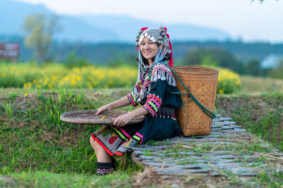 Full length of woman sitting on field