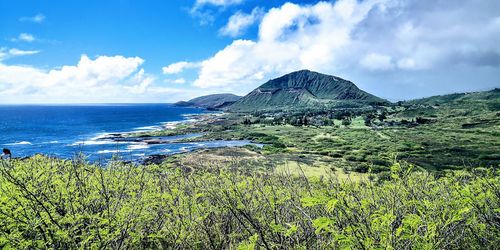 Panoramic view of sea and mountains against sky