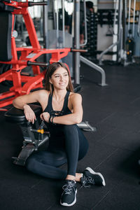 Portrait of woman exercising in gym