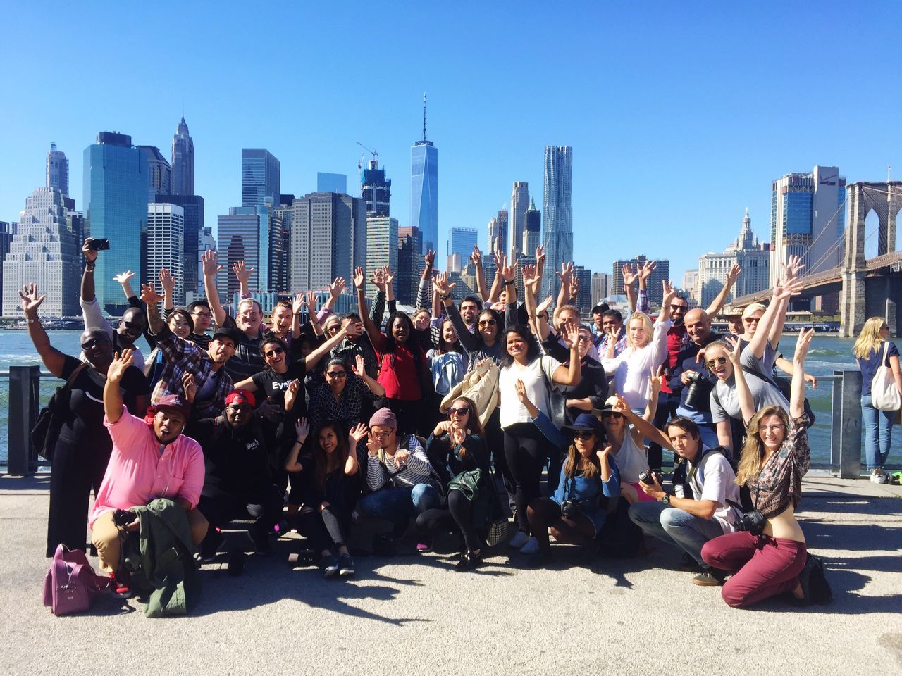 city, large group of people, building exterior, architecture, clear sky, tall - high, skyscraper, built structure, person, lifestyles, tower, city life, full length, urban skyline, crowded, togetherness, crowd, outdoors, day, event, performance, blue