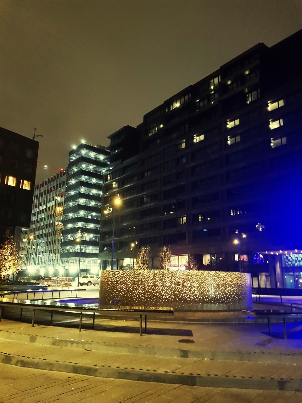 ILLUMINATED MODERN BUILDINGS AT NIGHT