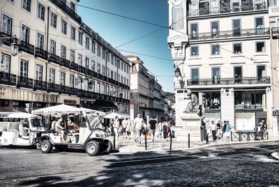 View of city street and buildings against sky