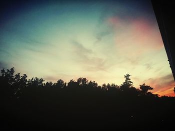 Silhouette trees against sky during sunset