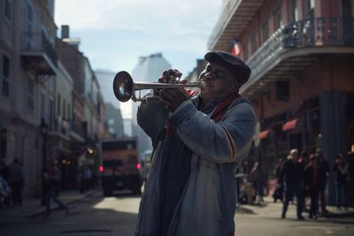 Side view of man playing in city