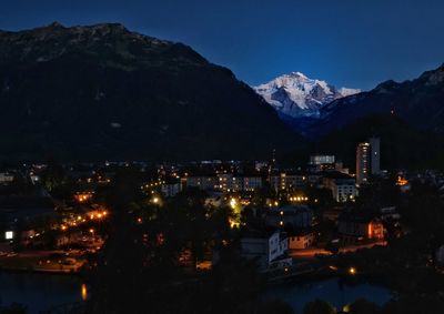 High angle view of city lit up at night