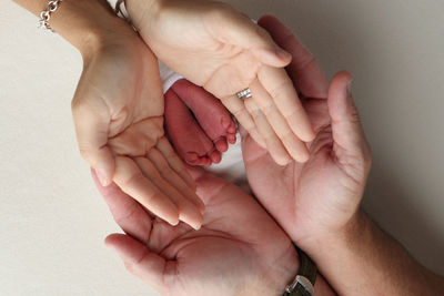 Cropped image of hand against wall