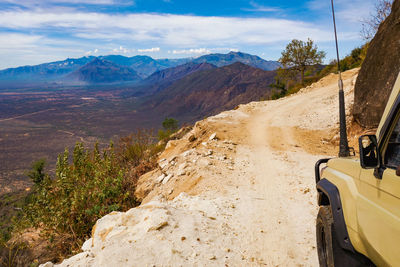 Side view of a safari vehicle against a mountain range in west pokot, kenya