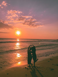 Woman on beach during sunset