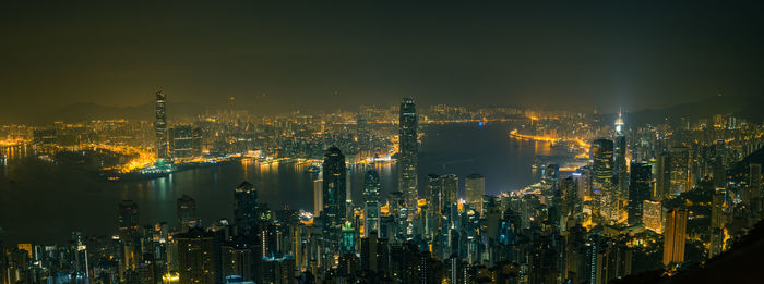 Illuminated cityscape against sky at night