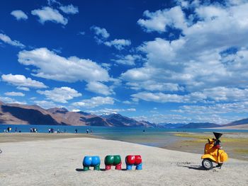 People on beach against sky