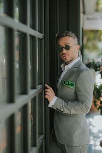 Young man wearing sunglasses standing outdoors