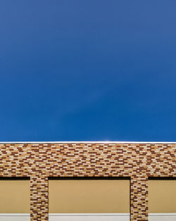 Low angle view of building against blue sky