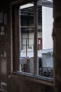 Abandoned building seen through window