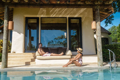 Low section of woman relaxing in swimming pool