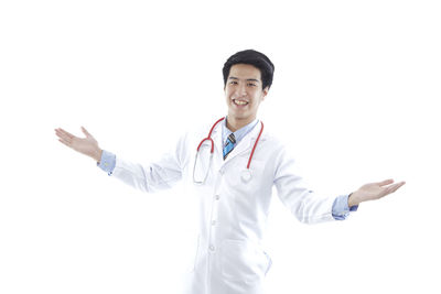 Portrait of smiling young man against white background