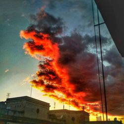 Low angle view of fire against sky during sunset