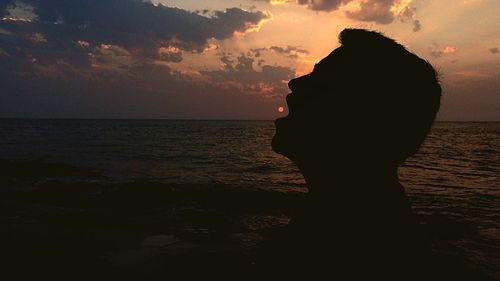 Silhouette of man at beach during sunset