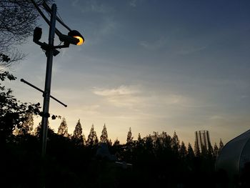 Low angle view of street light against sky at sunset