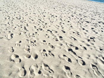 High angle view of footprints on sand at beach