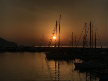 Sailboats in marina at sunset