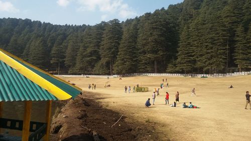 People playing in park against sky