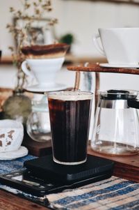 Close-up of iced coffee in glass on table at home