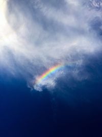 Low angle view of rainbow against sky