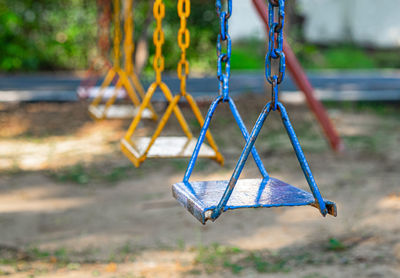 Close-up of empty swing in park