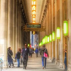 People walking in corridor of building