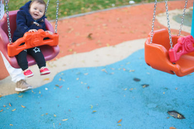 Girl playing on slide at playground