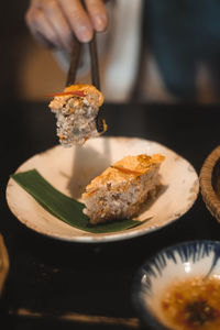Close-up of hand holding ice cream in plate