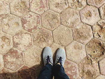 Low section of person standing on footpath