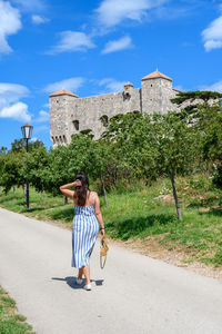 Woman from behind, old fort, castle, tourism, summer, sunny day. nehaj, senj, croatia.