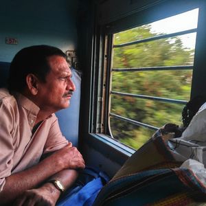 Man sitting on train window