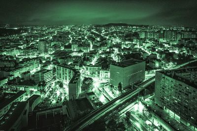 High angle view of illuminated cityscape against sky at night