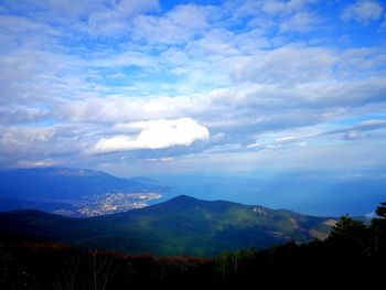 Scenic view of mountains against blue sky