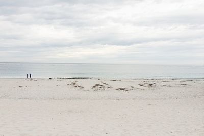 View of beach with people in distant