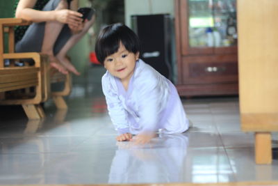 Portrait of smiling girl holding while standing on floor