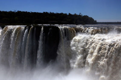 Scenic view of waterfall against clear sky
