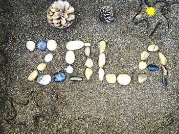 High angle view of pebbles on sand